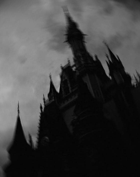 Gothic castle spires against a stormy sky, black and white